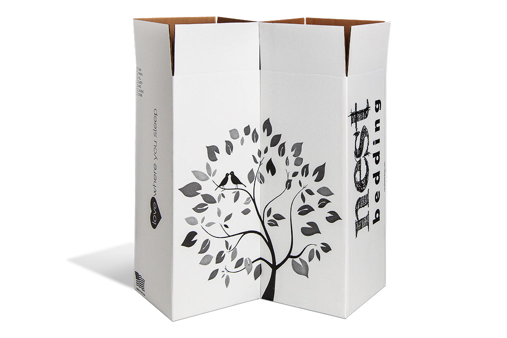 Two white Nest Bedding mattress boxes aligned to show the Nest Bedding tree logo. 